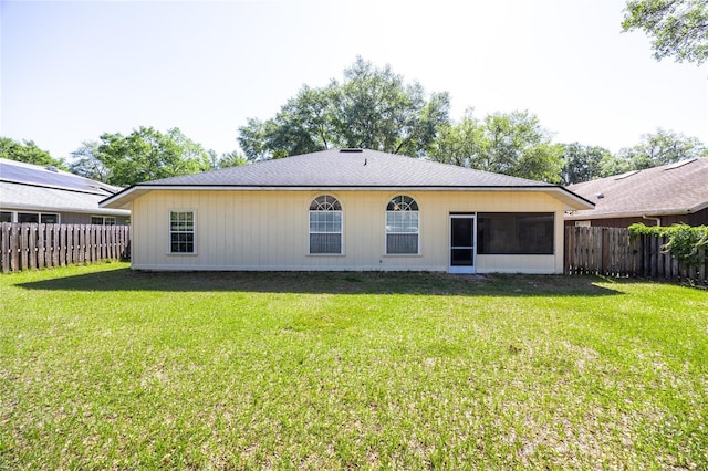 6114 NW 35th St, Gainesville, FL 32653 - rear view of house featuring a yard, a sunroom, and a fenced backyard