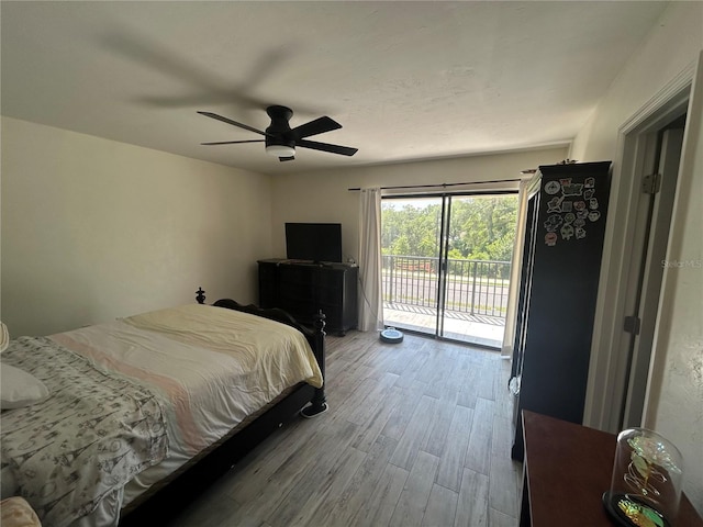 bedroom with wood finished floors, access to exterior, and ceiling fan