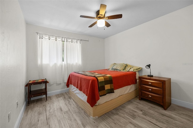 507 NW 39th Rd Unit 317, Gainesville, FL 32607 - bedroom with wood finished floors, baseboards, and a ceiling fan