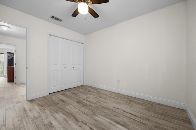 507 NW 39th Rd Unit 317, Gainesville, FL 32607 - unfurnished bedroom featuring light wood-type flooring, baseboards, a closet, and ceiling fan