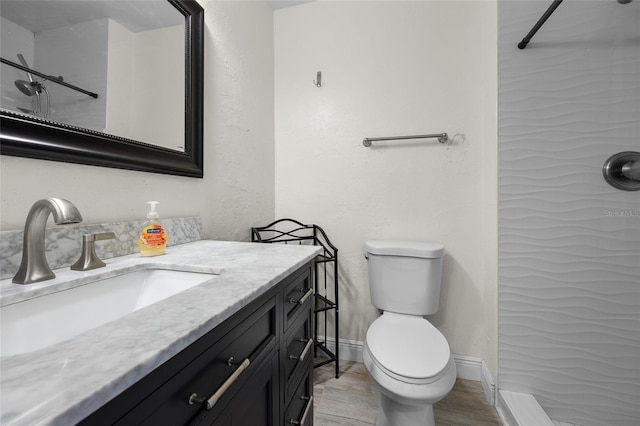 507 NW 39th Rd Unit 317, Gainesville, FL 32607 - full bath with wood finished floors, toilet, vanity, baseboards, and a shower