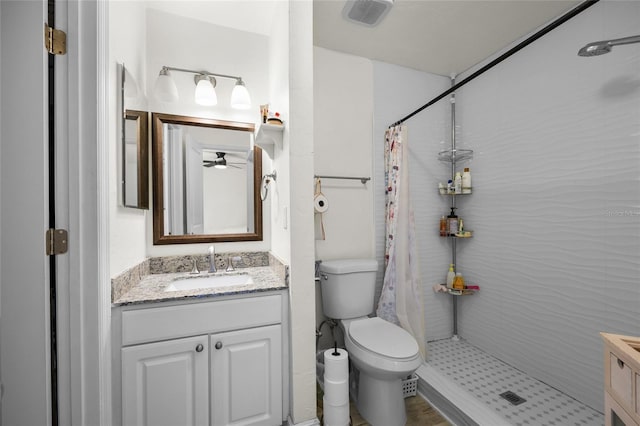 507 NW 39th Rd Unit 317, Gainesville, FL 32607 - full bathroom featuring vanity, curtained shower, toilet, and a ceiling fan