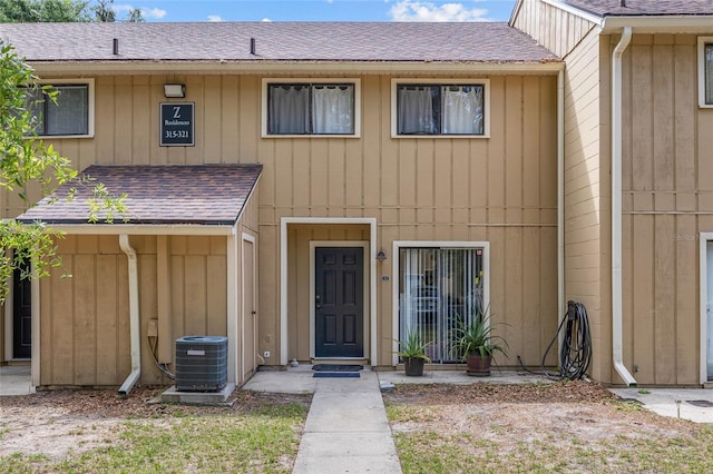 507 NW 39th Rd Unit 317, Gainesville, FL 32607 - townhome / multi-family property with central air condition unit and a shingled roof