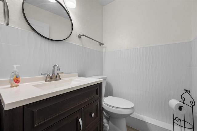 507 NW 39th Rd Unit 317, Gainesville, FL 32607 - bathroom featuring vanity, toilet, and a wainscoted wall