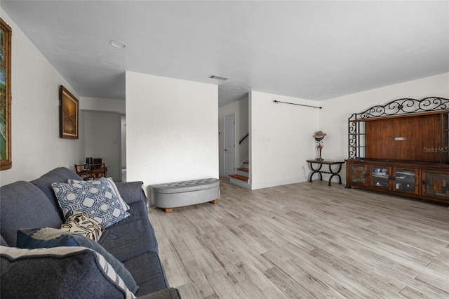507 NW 39th Rd Unit 317, Gainesville, FL 32607 - living area featuring light wood-style flooring, stairs, and baseboards