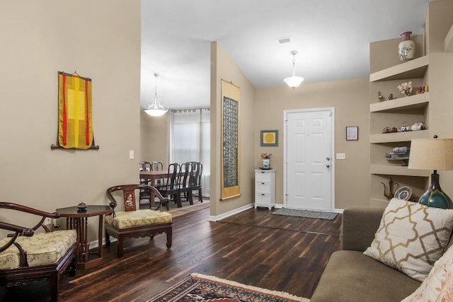 8145 SW 51st Rd, Gainesville, FL 32608 - living room with wood finished floors, lofted ceiling, baseboards, and built in features