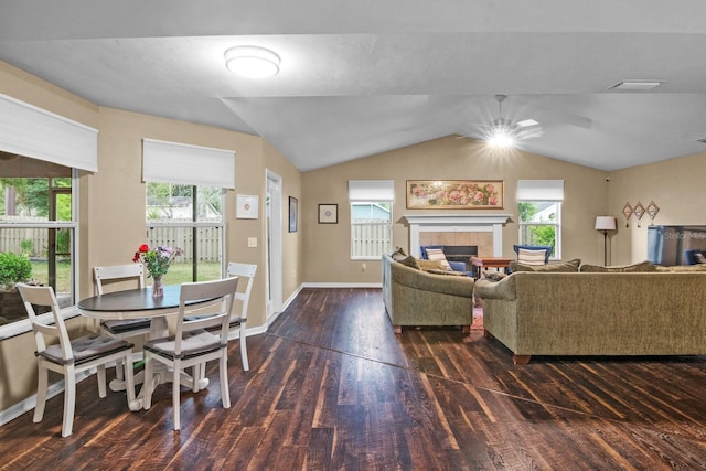 8145 SW 51st Rd, Gainesville, FL 32608 - living area featuring wood finished floors, healthy amount of natural light, a tiled fireplace, and vaulted ceiling