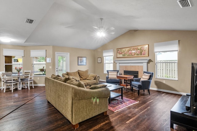 8145 SW 51st Rd, Gainesville, FL 32608 - living area featuring dark wood finished floors, a ceiling fan, lofted ceiling, a tiled fireplace, and baseboards