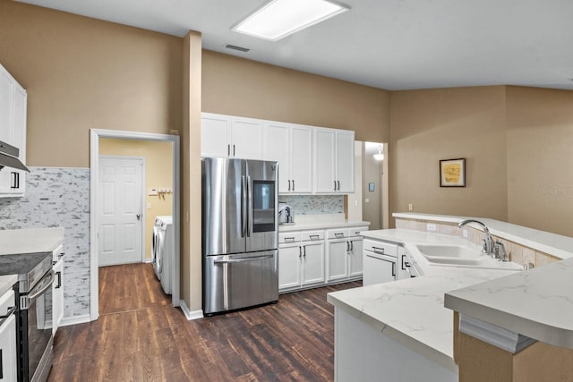8145 SW 51st Rd, Gainesville, FL 32608 - kitchen with appliances with stainless steel finishes, a sink, washer and dryer, dark wood-type flooring, and light stone counters