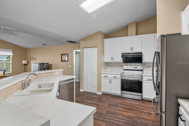 8145 SW 51st Rd, Gainesville, FL 32608 - kitchen featuring stainless steel appliances, a sink, lofted ceiling, dark wood-style flooring, and white cabinets