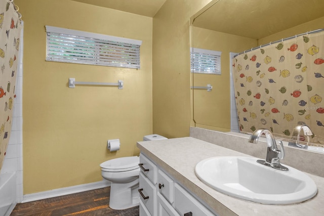 8145 SW 51st Rd, Gainesville, FL 32608 - bathroom with wood finished floors, toilet, vanity, a shower with curtain, and baseboards