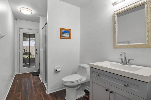 8145 SW 51st Rd, Gainesville, FL 32608 - bathroom featuring wood finished floors, toilet, a shower stall, vanity, and baseboards