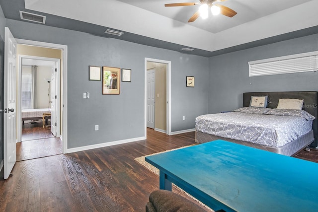 8145 SW 51st Rd, Gainesville, FL 32608 - bedroom featuring wood finished floors, baseboards, a tray ceiling, and a ceiling fan