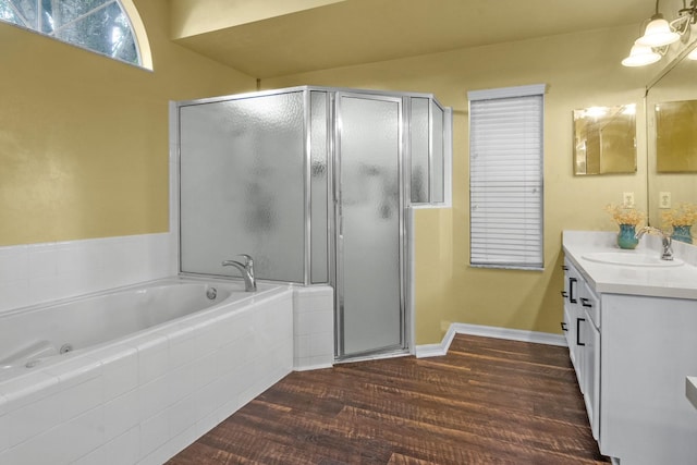 8145 SW 51st Rd, Gainesville, FL 32608 - bathroom with vanity, a shower stall, a garden tub, and wood finished floors