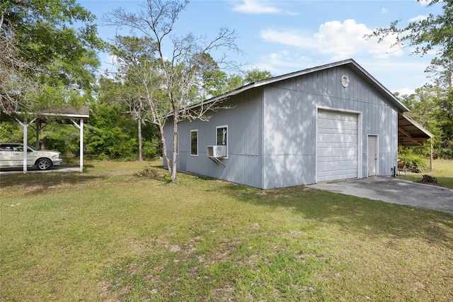 view of property exterior with a lawn, cooling unit, aphalt driveway, and a detached garage