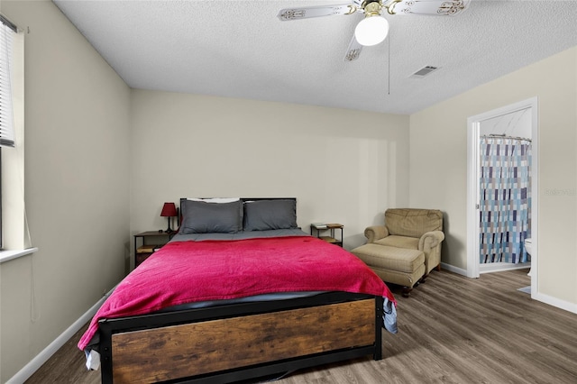 bedroom featuring a textured ceiling, ceiling fan, wood finished floors, and baseboards