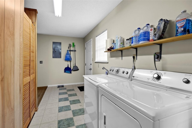 washroom with washing machine and dryer, electric panel, laundry area, and baseboards