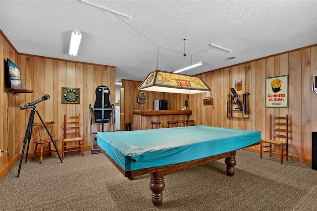 game room featuring wood walls, carpet, billiards, and a textured ceiling