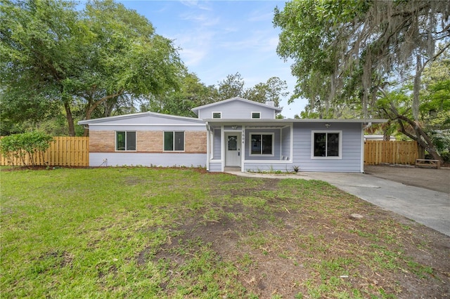 1604 NE 7th St, Gainesville, FL 32609 - ranch-style house with brick siding, a front lawn, and fence