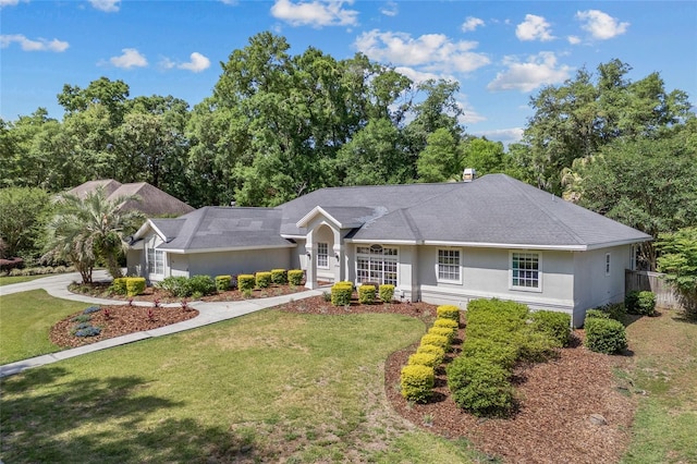 ranch-style home with a front lawn and stucco siding