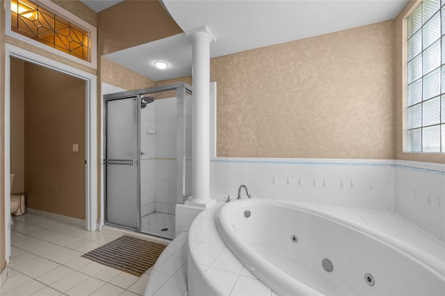 full bathroom with a stall shower, a whirlpool tub, toilet, and ornate columns