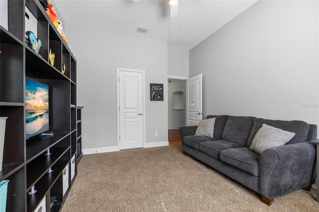 living room featuring carpet floors, ceiling fan, and baseboards