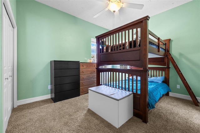 carpeted bedroom featuring baseboards and a ceiling fan