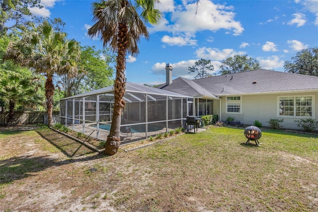 rear view of property featuring stucco siding and a lanai