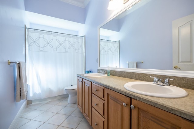 10312 SW 23rd Ave, Gainesville, FL 32607 - bathroom with double vanity, toilet, ornamental molding, tile patterned floors, and plenty of natural light