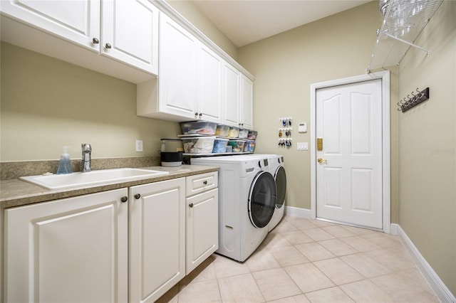 10312 SW 23rd Ave, Gainesville, FL 32607 - laundry area with cabinet space, washer and dryer, light tile patterned floors, and baseboards
