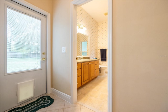 10312 SW 23rd Ave, Gainesville, FL 32607 - bathroom featuring toilet, vanity, tile patterned flooring, and baseboards