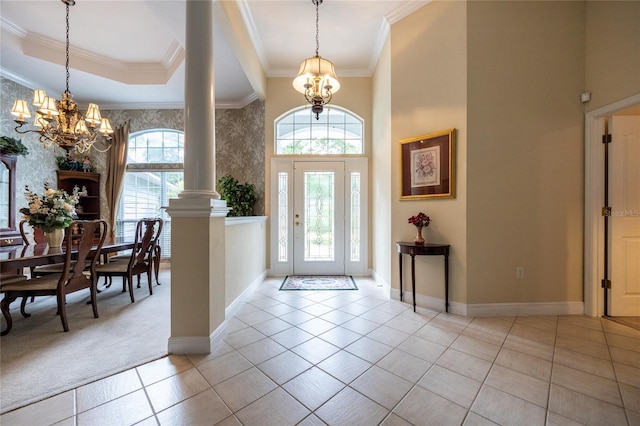 10312 SW 23rd Ave, Gainesville, FL 32607 - tiled entrance foyer featuring a chandelier, baseboards, crown molding, ornate columns, and a high ceiling