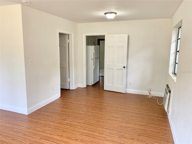 1041 NE 10th Ave, Gainesville, FL 32601 - empty room featuring light wood-style flooring and baseboards