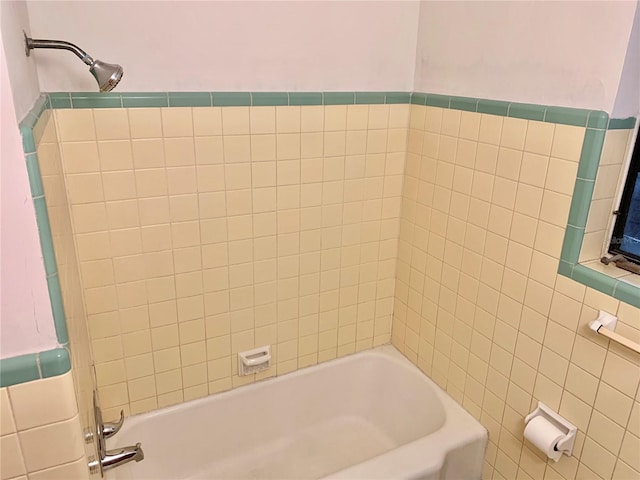 1041 NE 10th Ave, Gainesville, FL 32601 - bathroom with tile walls and washtub / shower combination