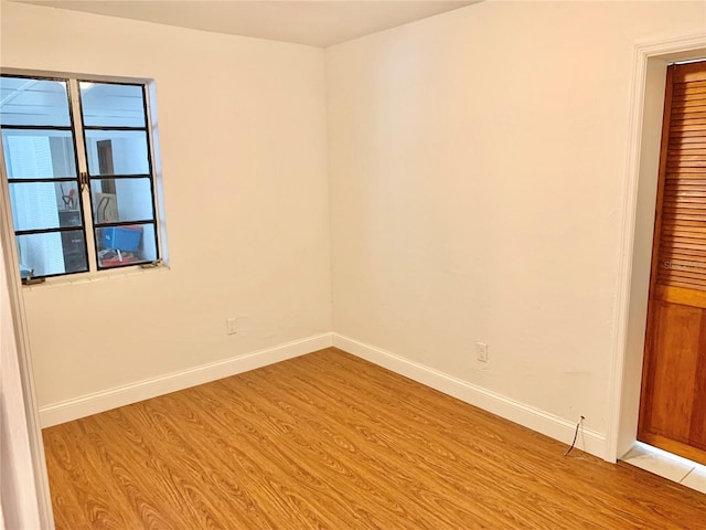 1041 NE 10th Ave, Gainesville, FL 32601 - spare room featuring light wood-type flooring and baseboards