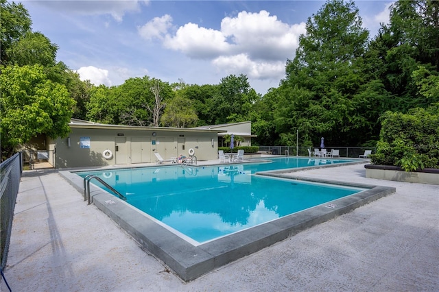 community pool featuring a patio and fence