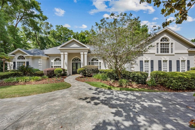 neoclassical home with stucco siding