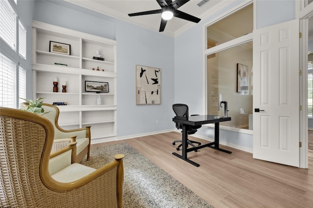 4606 SW 97th Ter, Gainesville, FL 32608 - home office with light wood-type flooring, crown molding, ceiling fan, plenty of natural light, and baseboards