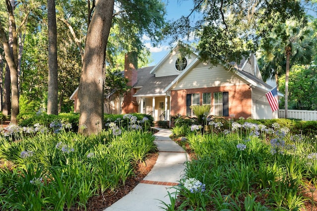 4319 SW 86th Way, Gainesville, FL 32608 - view of front of home featuring brick siding, a chimney, and a garage