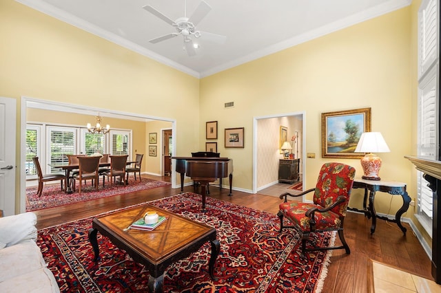 4319 SW 86th Way, Gainesville, FL 32608 - living area with a high ceiling, crown molding, wood finished floors, a chandelier, and ceiling fan