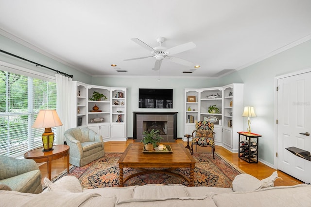 4319 SW 86th Way, Gainesville, FL 32608 - living room with ceiling fan, crown molding, wood finished floors, a tile fireplace, and recessed lighting
