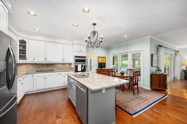4319 SW 86th Way, Gainesville, FL 32608 - kitchen featuring appliances with stainless steel finishes, light stone countertops, white cabinetry, a chandelier, and ornamental molding