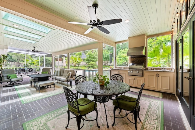 4319 SW 86th Way, Gainesville, FL 32608 - sunroom featuring a skylight, ceiling fan, and outdoor dining area