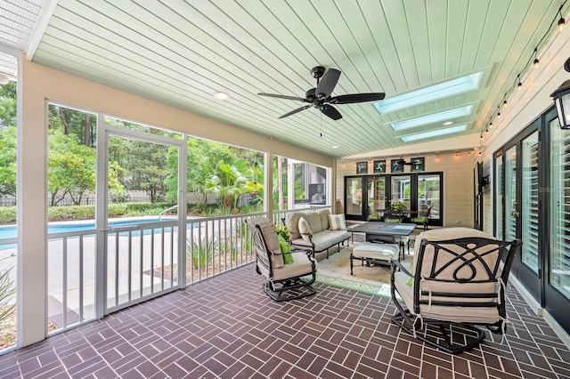 4319 SW 86th Way, Gainesville, FL 32608 - sunroom / solarium featuring a ceiling fan, an outdoor living space, a skylight, and healthy amount of natural light