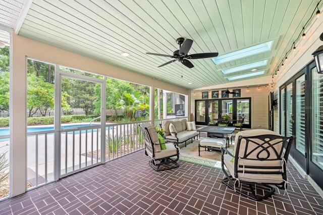 4319 SW 86th Way, Gainesville, FL 32608 - sunroom / solarium featuring a ceiling fan, an outdoor living space, a skylight, and healthy amount of natural light