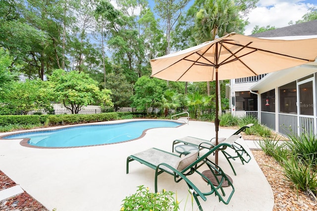 4319 SW 86th Way, Gainesville, FL 32608 - view of swimming pool featuring a patio, a sunroom, and view of scattered trees