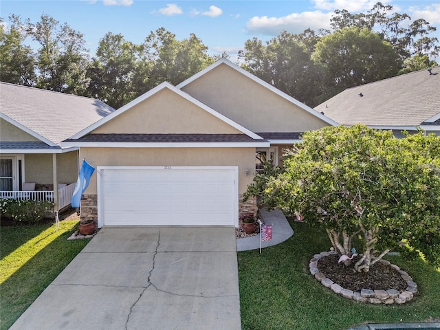 view of side of home featuring stone siding, stucco siding, an attached garage, and a lawn