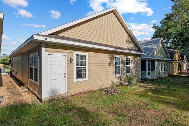 back of property featuring a yard and central AC unit