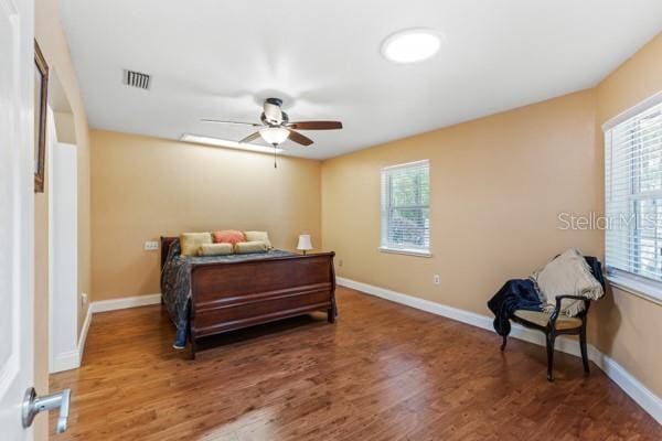 23225 NW County Rd 236, High Springs, FL 32643 - bedroom with baseboards, visible vents, and wood finished floors