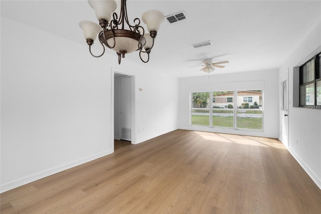 529 NE 12th Ct, Gainesville, FL 32601 - unfurnished dining area with a chandelier, light wood-style flooring, ceiling fan, and baseboards